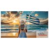 A girl standing on the beach with a greek flag in the hand