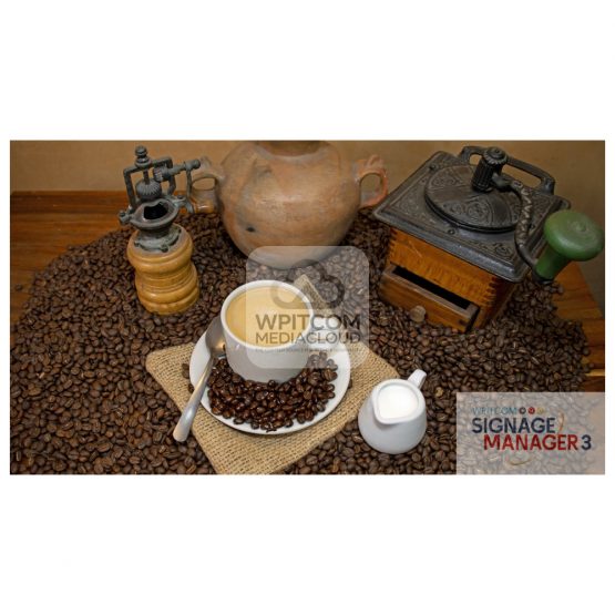 A cup of black coffee with cream on a table with beans