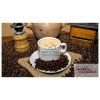 A cup of black coffee with cream on a table