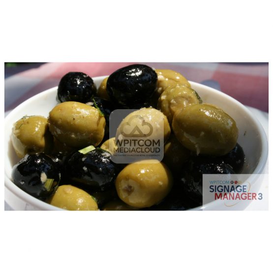 Background with a bowl of green and black olives